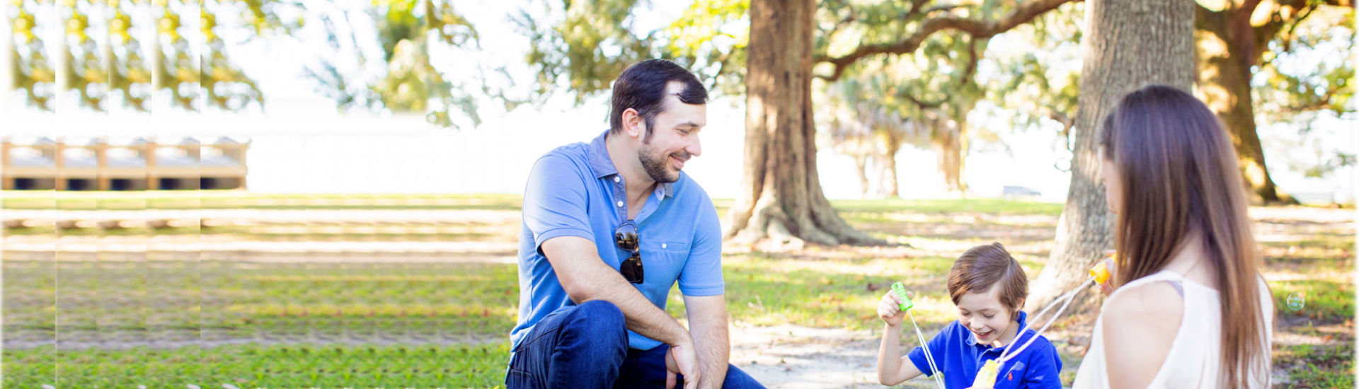 Family outside blowing bubbles.